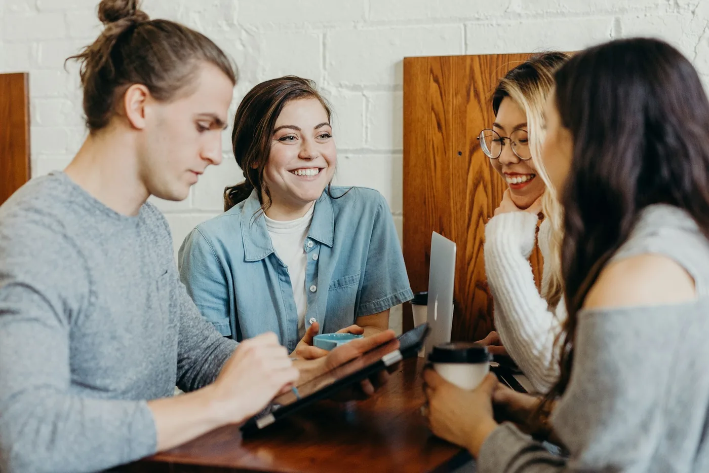 A group of colleagues talking together over coffee