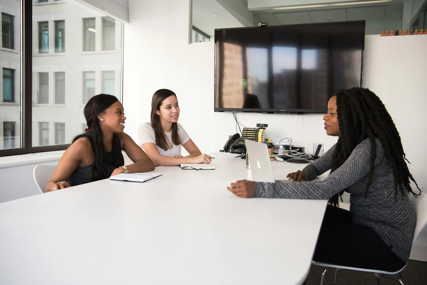 Three colleagues in a meeting at a conference table